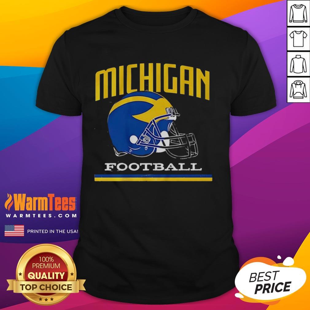 Alt Text: Vintage Michigan Wolverines football helmet graphic on a classic T-shirt, perfect for fans of college football.