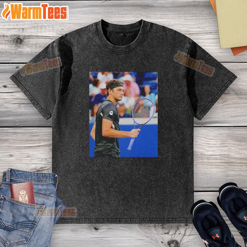 Taylor Fritz wearing a stylish washed t-shirt during the 2025 US Open tennis tournament.