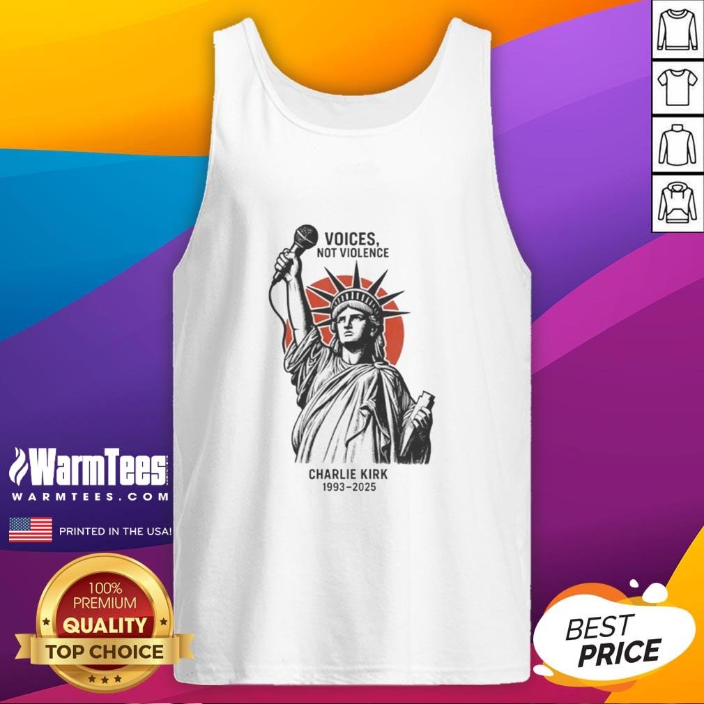 Charlie Kirk wearing a 'Voices Not Violence' tank top in front of the Statue of Liberty, promoting peace and unity.