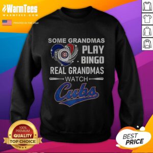 Grandmas wearing 'Real Grandmas Watch Cubs' sweatshirt enjoy bingo at a Chicago Cubs baseball game, showcasing team spirit.