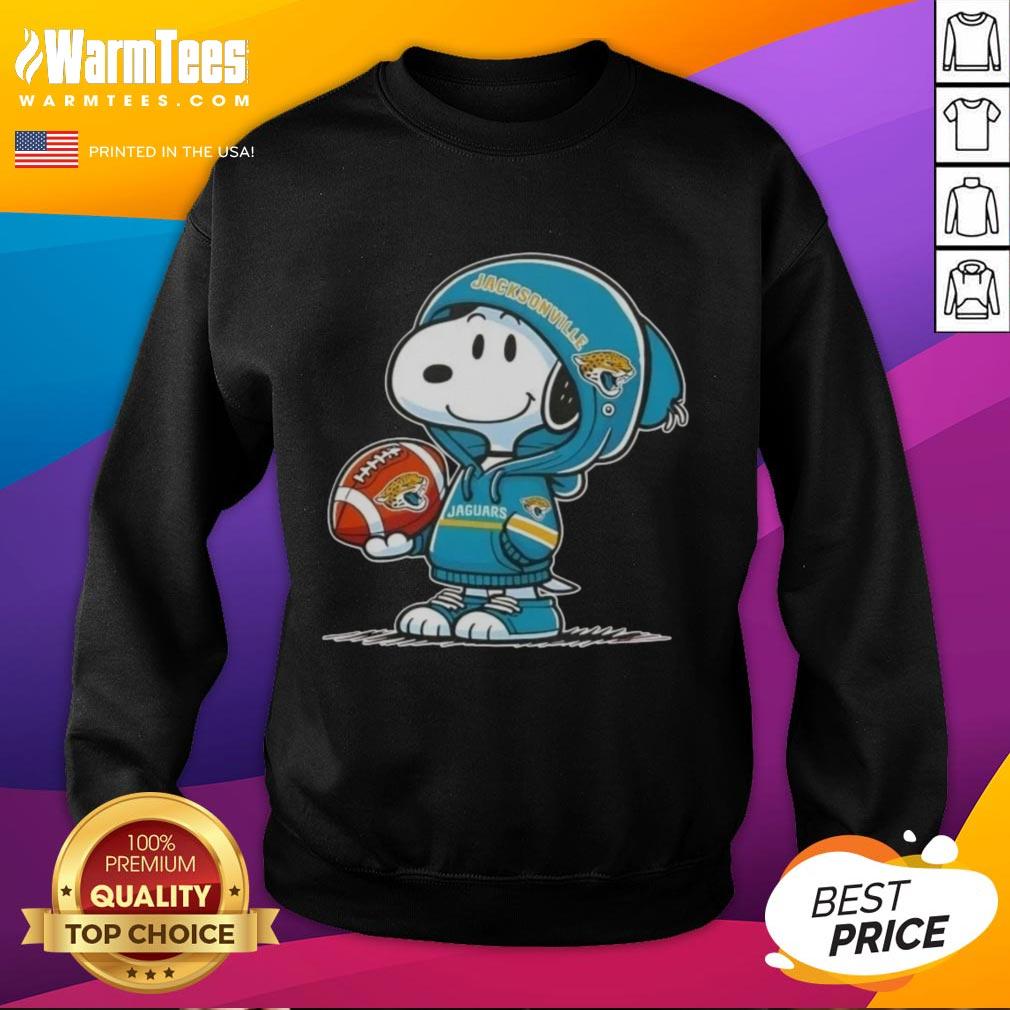Cute Peanuts Snoopy wearing a Jacksonville Jaguars hoodie, smiling at fans in a cozy sweatshirt.