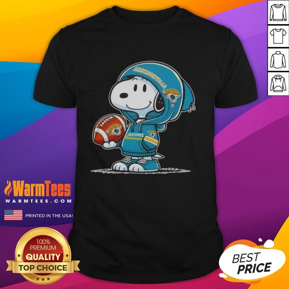 Alt Text: Cute Peanuts Snoopy in a Jacksonville Jaguars hoodie, smiling at fans on a fun T-shirt design.