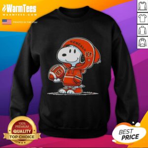 Snoopy in a Cincinnati Bengals hoodie smiles at fans, showcasing the Good Peanuts sweatshirt in a fun, playful setting.