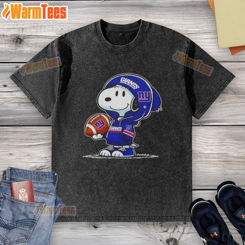 Alt Text: Snoopy wearing a New York Giants hoodie smiles at fans on a washed t-shirt featuring pretty peanuts design.