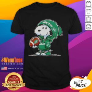 Alt Text: Snoopy in a hoodie, smiling at fans on a New York Jets T-shirt featuring Pretty Peanuts design.