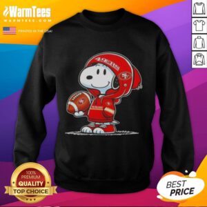 Alt Text: Snoopy in a hoodie smiles at fans, showcasing a Pretty Peanuts sweatshirt with San Francisco 49ers logo.