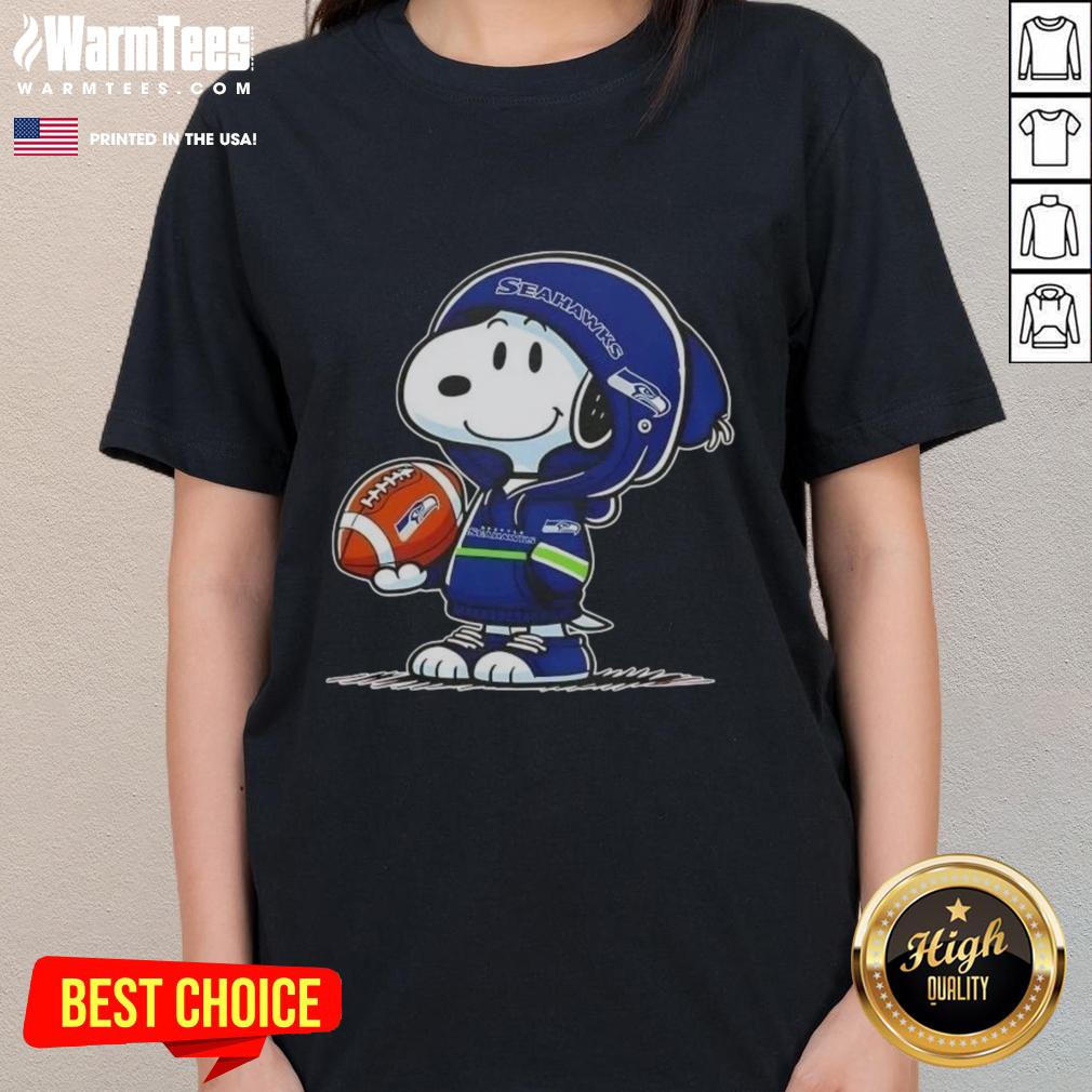Alt Text: Snoopy in a Seattle Seahawks hoodie smiles at fans, featured on a Pretty Peanuts ladies tee, perfect for football lovers.