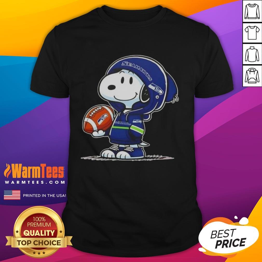 Alt Text: Snoopy in a Seahawks hoodie smiles at fans on a t-shirt, showcasing a fun Pretty Peanuts design.