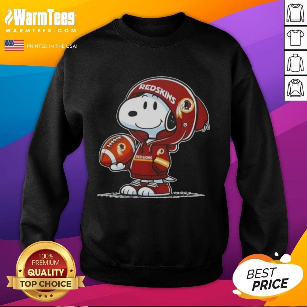 Alt Text: Snoopy in a hoodie featuring Washington Commanders, smiling at fans while wearing a stylish sweatshirt.