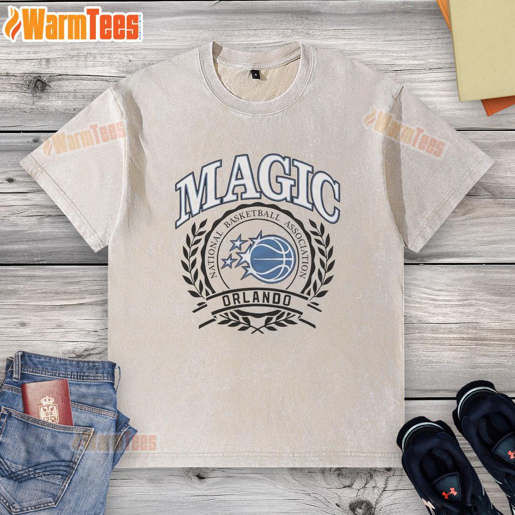 Alt Text: Retro washed t-shirt featuring the Orlando Magic NBA logo framed by a laurel wreath for basketball fans.
