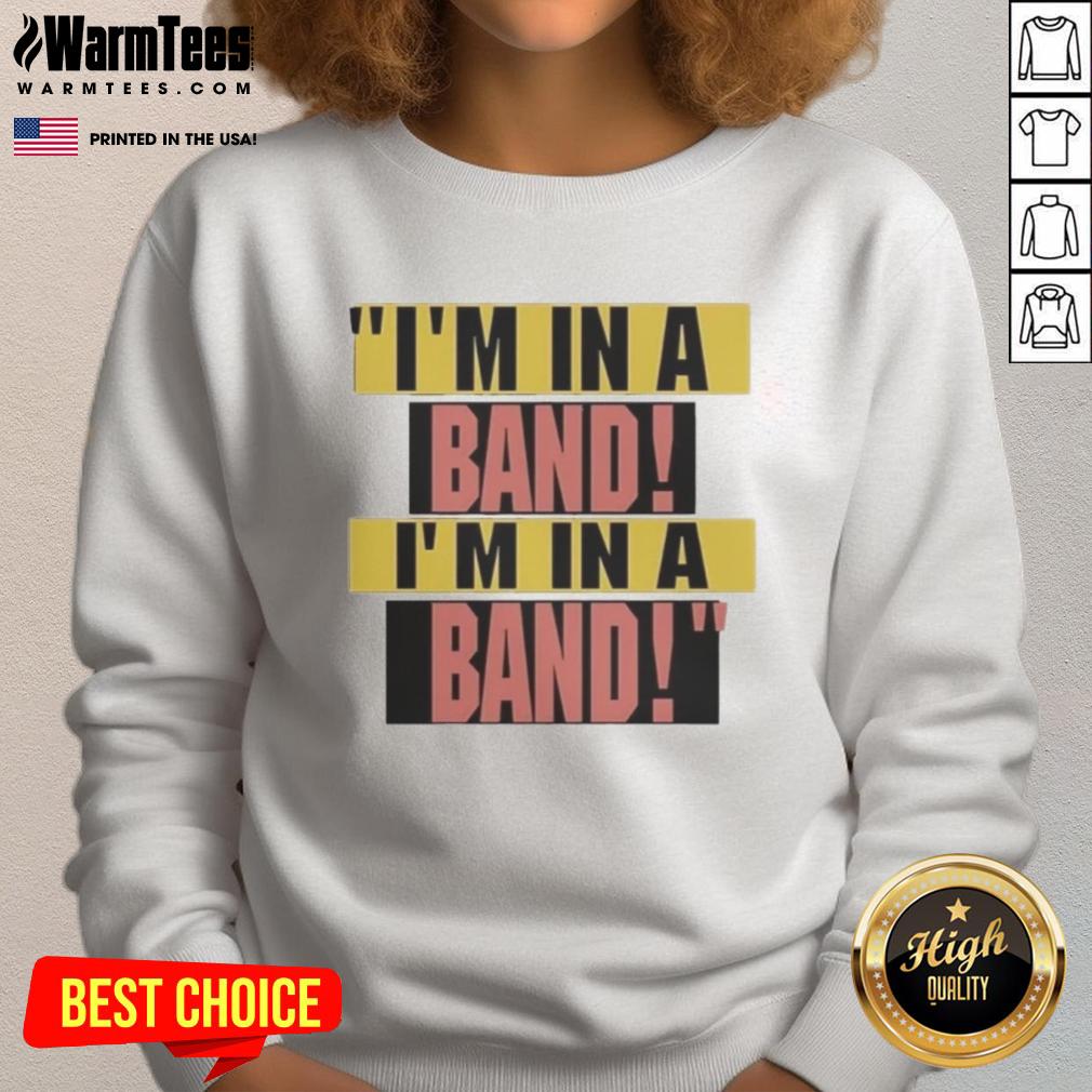 Alt Text: Hayley Williams wearing a stylish I'm In A Band sweatshirt, showcasing her unique fashion sense and musical passion.