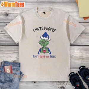 Top Grinch 'I Hate People But I Love My Buffalo Bills' Merry Christmas washed t-shirt displayed on a festive background.