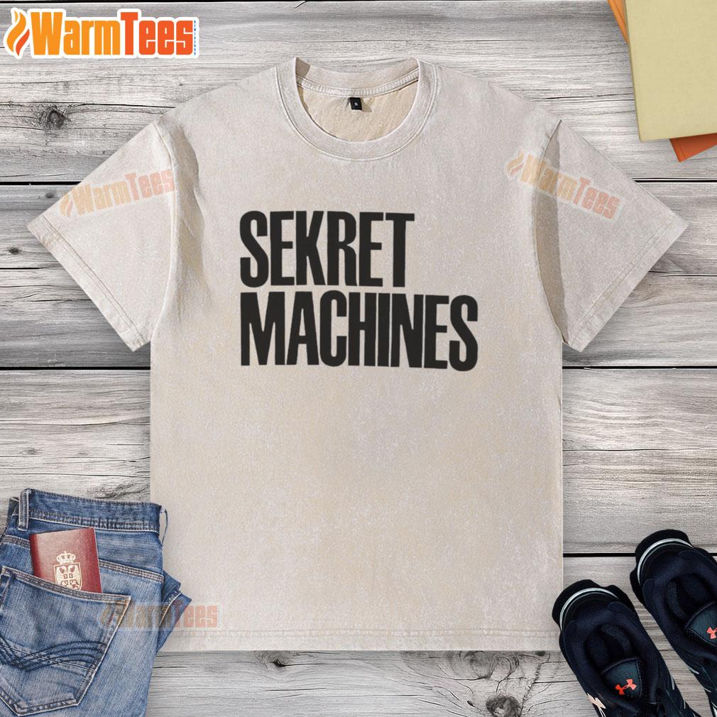 Top Sekret Machines washed t-shirt displayed on a wooden surface, featuring a vintage-style graphic and soft fabric.