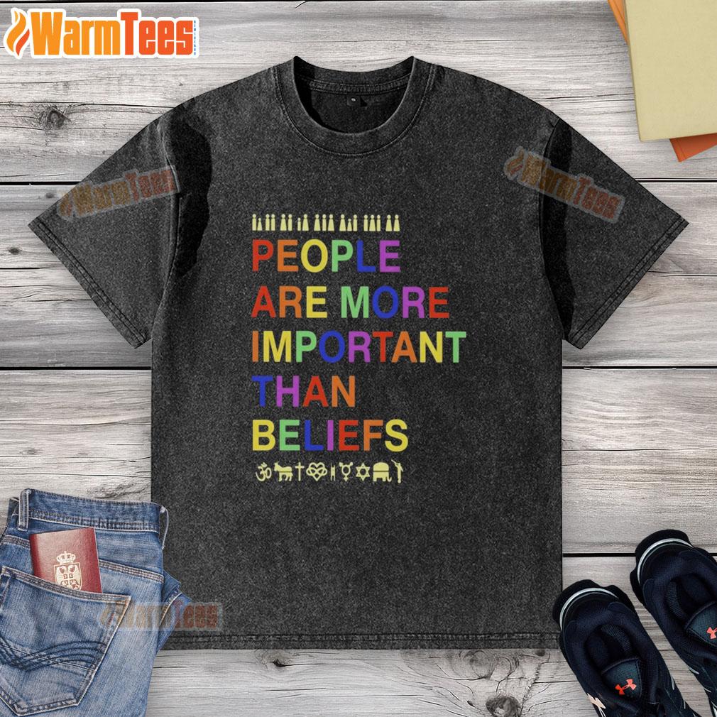 Original People Are More Important Than Beliefs washed t-shirt displayed on a wooden background, showcasing its unique design.