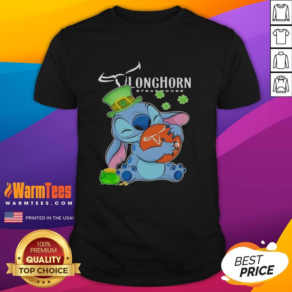 Alt Text: Cute Stitch hugging Texas Longhorn Steakhouse logo on a Happy St. Patrick's Day T-shirt for festive celebrations.