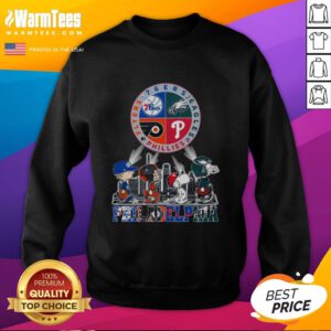Alt Text: Cozy sweatshirt featuring Snoopy with Philadelphia sports teams: 76ers, Eagles, Flyers, and Phillies logos.