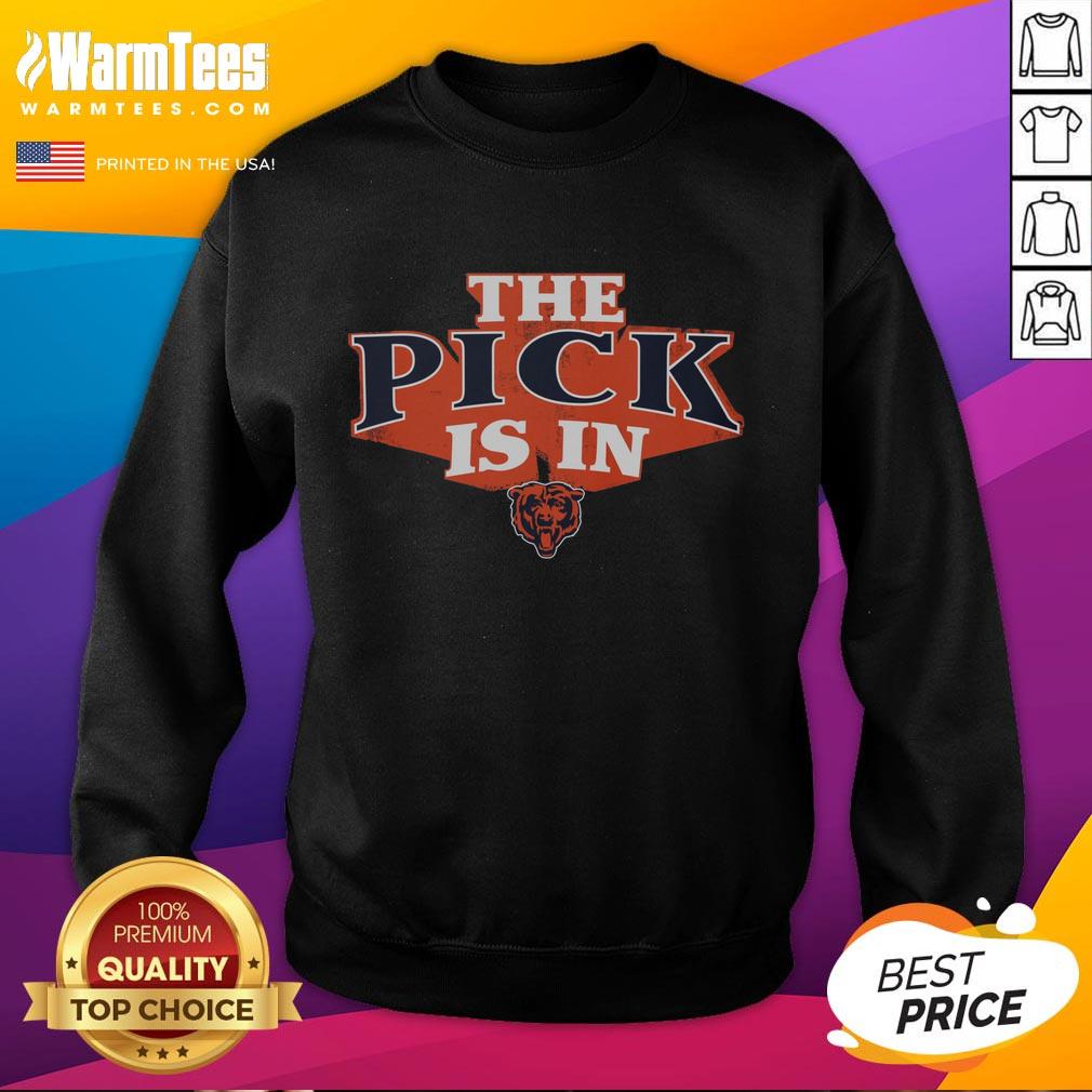 Chicago Bears fan wearing a 'Good Chicago Bears Pick Is In' sweatshirt, celebrating a draft selection at a sports event.