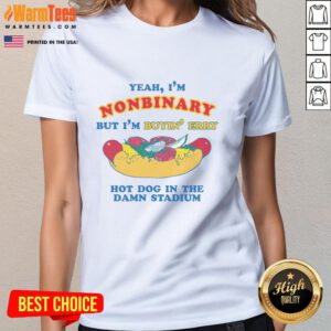 Nonbinary person wearing a 'Good Yeah I'm Nonbinary But I'm Buyin' Erry Hot Dog In The Stadium' tee at a stadium.