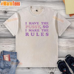 Trendy 'Nice I Have The Pussy So I Make The Rules' washed t-shirt displayed on a wooden background, showcasing bold typography.