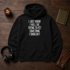 Good I Just Know I Will Die Trying To Pet Something I Shouldn'T Hoodie in dark gray, front view with kangaroo pocket and drawstring hood