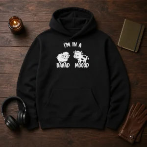 Hot Sheep And Cow I Am In A Baaad Moood Hoodie in black, featuring a playful graphic design on the front