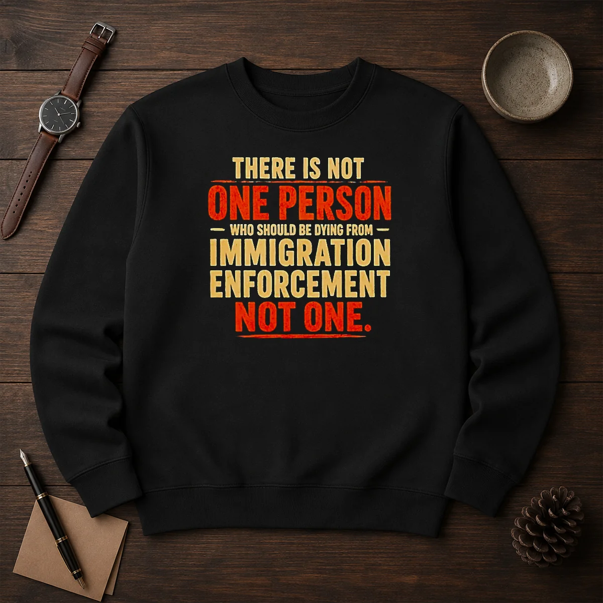 Original There Is Not One Person WHO Should Be Dying From Immigration Enforcement sweater in black, crewneck style with bold white text
