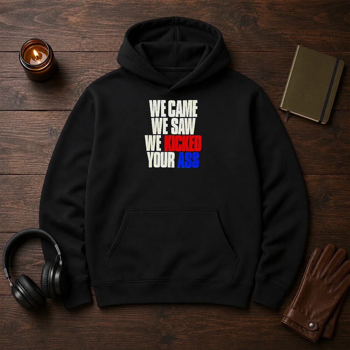 Top We Came We Saw We Kicked Your Ass Hoodie in black, front view with kangaroo pocket and drawstring hood